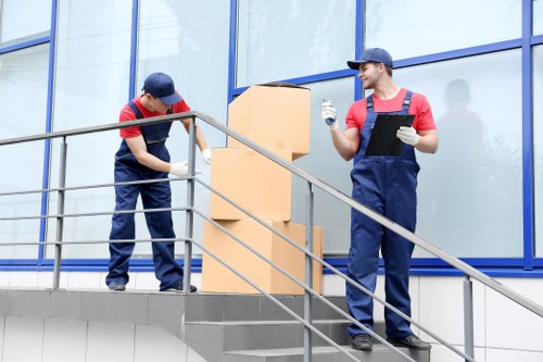 Professional movers packing office equipment