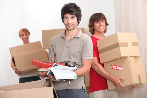 Professional movers handling a large furniture item