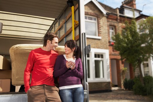 Happy customers unloading furniture from a van